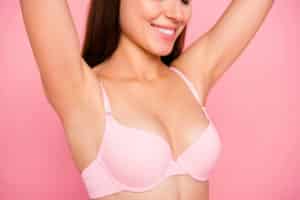 girl in beige bra perfect shape form line curves chest raising hands up