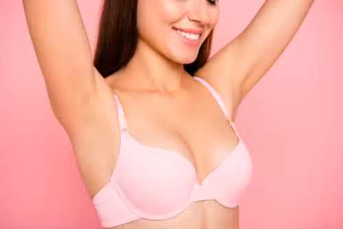 girl in beige bra perfect shape form line curves chest raising hands up