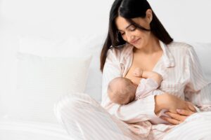 New mother breastfeeds her infant, happy to nourish her child